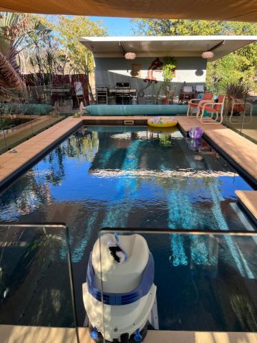 a swimming pool with a fountain in a house at Almost Off Grid Tranquillity in Katherine