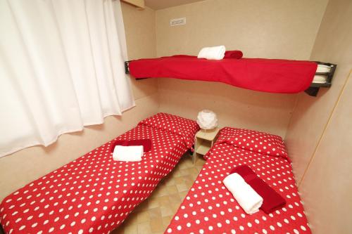 two beds in a room with red and white polka dots at Family friendly apartments with a swimming pool Bol, Brac - 13364 in Bol