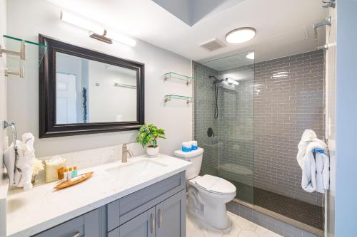 a bathroom with a sink and a toilet and a shower at Tropical Retreat Near Waikiki Beach with Parking in Honolulu