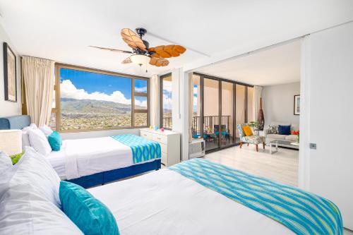 a bedroom with two beds and a large window at Tropical Retreat Near Waikiki Beach with Parking in Honolulu