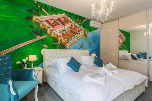 a bedroom with a white bed with a green wall at Luxury villa with a swimming pool Split - 13408 in Split