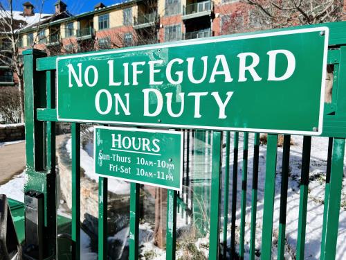 a green sign that says no lifeguard on duty at Mountain Creek Resort at Appalachian Hotel - Pool & Hot Tub in Vernon Township