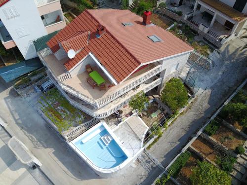 an overhead view of a large house with a swimming pool at Seaside house with a swimming pool Okrug Donji, Ciovo - 13428 in Okrug Donji