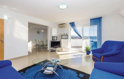 a living room with a blue couch and a glass table at Apartments with a parking space Kastav, Opatija - 13457 in Kastav