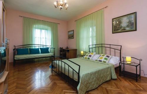 a bedroom with two beds and a couch at Apartments with a swimming pool Krsan, Central Istria - Sredisnja Istra - 13521 in Kršan