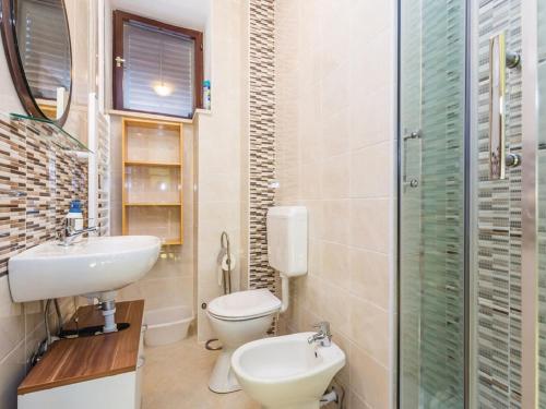 a bathroom with a sink and a toilet and a shower at Apartments with a parking space Kastav, Opatija - 13568 in Kastav