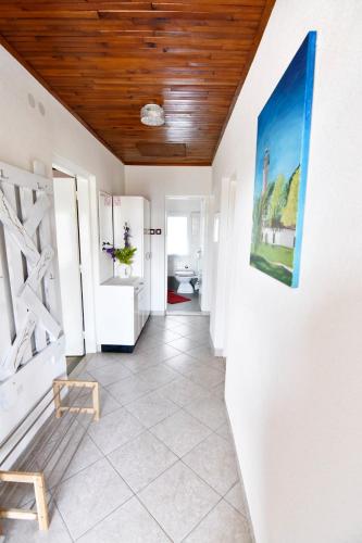 a hallway with white walls and a wooden ceiling at Apartment Savudrija 13589a in Savudrija