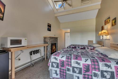 a bedroom with a bed and a microwave on a desk at Blue Moon Resort & Motel in Hill City