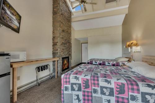 a bedroom with a bed and a brick wall at Blue Moon Resort & Motel in Hill City