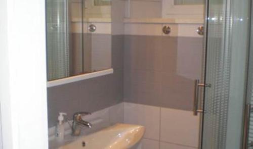 a bathroom with a sink and a glass shower at Apartments by the sea Brna, Korcula - 13618 in Smokvica