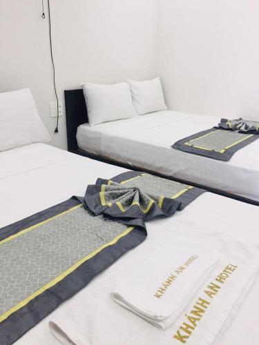 two beds in a room with towels on the floor at Khánh An Hotel in Nha Trang