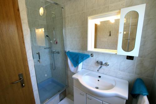 a bathroom with a sink and a shower and a mirror at Apartments and rooms by the sea Pirovac, Sibenik - 13654 in Pirovac