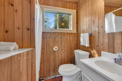 a wooden bathroom with a toilet and a sink at Blue Moon Resort & Motel in Hill City
