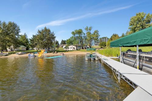 a view of the water with a dock and a playground at Blue Moon Resort & Motel in Hill City
