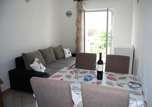 stół jadalny z butelką wina w obiekcie Apartments by the sea Lumbarda, Korcula - 12839 w mieście Lumbarda