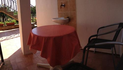 a bathroom with a table and a sink in a room at Double Room Zambratija 11875a in Zambratija