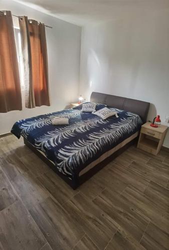 a large bed in a bedroom with a wooden floor at Apartments with parking space Zavalatica, Korcula - 9690 in Zavalatica