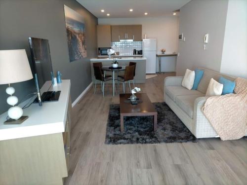 a living room with a couch and a table at Apartment 3 Wallaroo Marina in Wallaroo