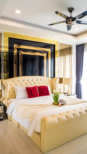 a large bedroom with a large bed with red pillows at 5BD Luxury Pool Villa Pattaya - Exquisite Pool Villa C in Pattaya South