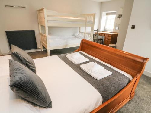 a bedroom with a bed and a bunk bed at Box Tree Farm House in Lancaster