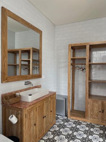 a bathroom with a sink and a mirror at The Seaglass Villas Bingin in Uluwatu