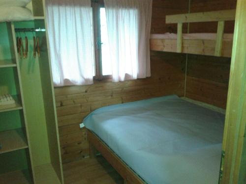 a small room with a bunk bed and a window at Secluded fisherman's cottage Cove Komornik, Pasman - 14801 in Pašman