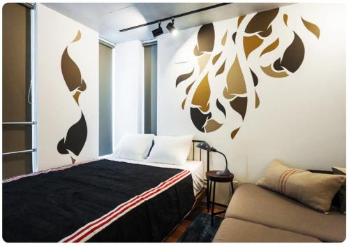a bedroom with a bed and a couch at The Aoca Tokyo Sanno in Tokyo