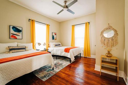 a bedroom with two beds and a ceiling fan at Happy Halliday-6 Min from Downtown San Antonio,TX in San Antonio