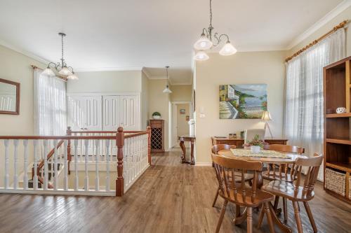 a dining room and living room with a table and chairs at Ballina Heritage Inn in Ballina