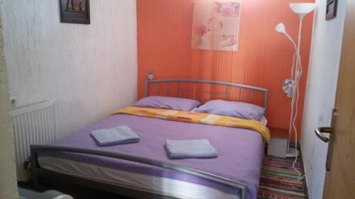 a bed in a small room with two towels on it at Apartments with a parking space Delnice, Gorski kotar - 14895 in Delnice
