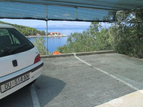 a white car parked in a parking lot with a view at Seaside holiday house Cove Bristva, Korcula - 14892 in Prizba