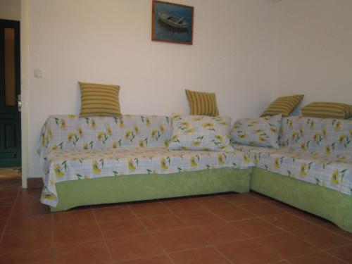 a green couch sitting in a living room at Seaside holiday house Cove Bristva, Korcula - 14892 in Prizba