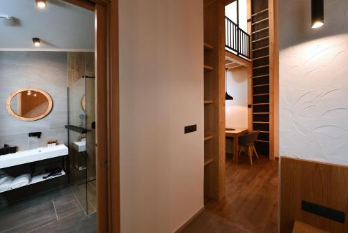 a bathroom with a sink and a mirror at APLEND Hotel Ovruč in Štrbské Pleso