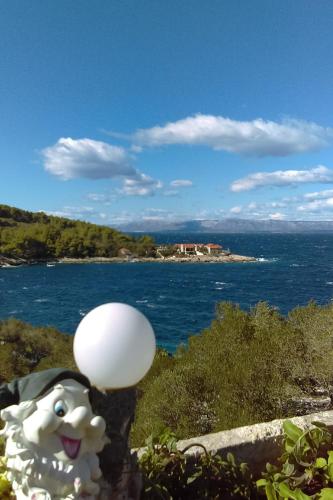a toy dog with a white ball on a cliff at Seaside holiday house Cove Bristva, Korcula - 14892 in Prizba