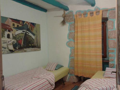 a room with two beds and a stone wall at Apartments with a parking space Porozina, Cres - 14980 in Filozići