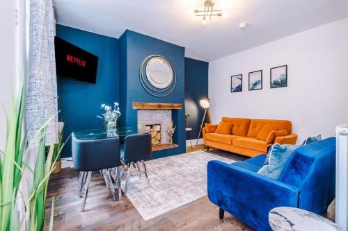 a blue living room with a couch and a table at Charming 3 Bed Home in the Garden Quarter, Chester in Chester