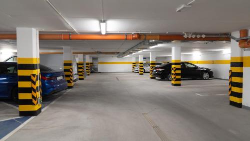 a parking garage with several cars parked in it at Toruńskie Zacisze 5 in Toruń