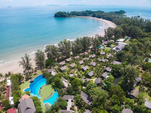 a beach filled with lots of palm trees at Twin Lotus Resort and Spa - SHA Plus in Ko Lanta