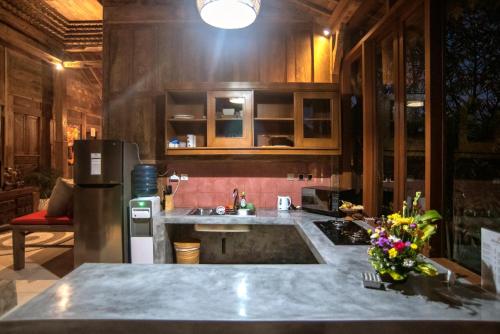 a kitchen with a sink and a refrigerator at PNB Bali Villas in Canggu