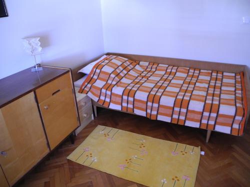 a small bedroom with a bed and a dresser at Apartments with WiFi Split - 15028 in Split
