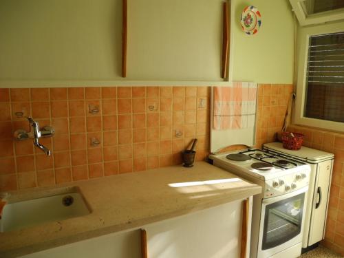 a kitchen with a stove and a counter top at Apartments with WiFi Split - 15028 in Split