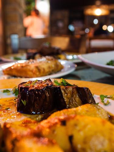 a table with two plates of food on it at Platanorema in Agios Ioannis Prodromos