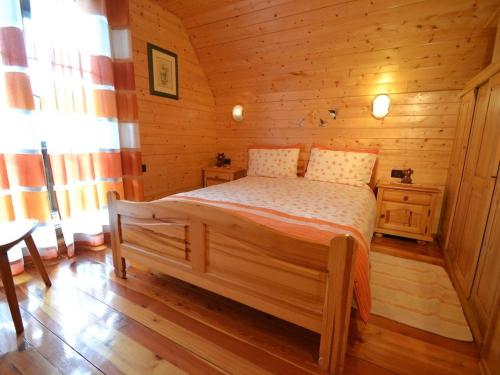 a bedroom with a bed in a wooden cabin at Holiday house with a parking space Crni Lug, Gorski kotar - 15058 in Crni Lug