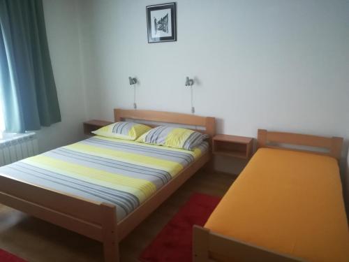a bedroom with a bed and a bench in it at Apartments with a parking space Lokve, Gorski kotar - 15061 in Lokve