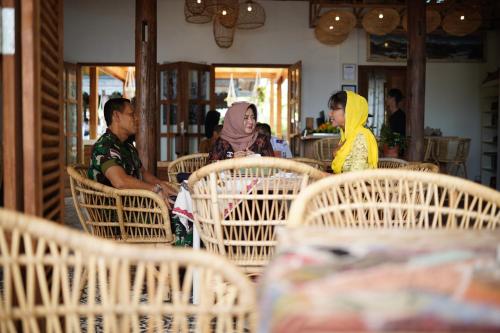 a group of people sitting at a table in a restaurant at Casa Nemo Beach Resort & Spa in Sabong
