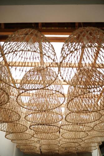 a group of nets hanging from a ceiling at Casa Nemo Beach Resort & Spa in Sabong