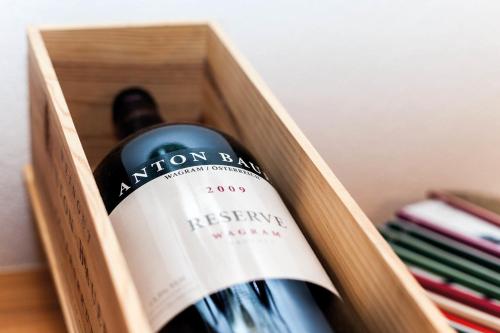 a bottle of wine in a wooden box at Rosa Canina Superior in Sankt Anton am Arlberg