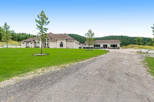 an empty road in front of a house at High Country Pool House in Sturgis