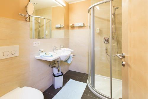 a bathroom with a sink and a shower at Rosa Canina Superior in Sankt Anton am Arlberg