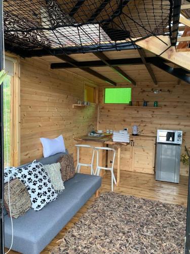 a room with a couch and a kitchen in a cabin at Mirador Valeisa in Guatavita